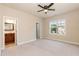 This bedroom features neutral paint colors, a window, and a ceiling fan at 2808 Carter Finley Pl, Raleigh, NC 27606