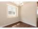 Dining area with hardwood floors, chandelier, and window at 2808 Carter Finley Pl, Raleigh, NC 27606