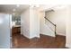 A naturally lit entryway features hardwood floors and a carpeted staircase at 2808 Carter Finley Pl, Raleigh, NC 27606