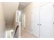 Upstairs hallway with white doors and a carpeted floor leads to the bedrooms at 2808 Carter Finley Pl, Raleigh, NC 27606