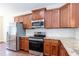 The kitchen features modern stainless steel appliances, granite countertops, and wooden cabinets at 2808 Carter Finley Pl, Raleigh, NC 27606