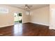 Spacious living room features hardwood floors, a ceiling fan, and a sliding door to the backyard at 2808 Carter Finley Pl, Raleigh, NC 27606