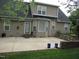 Spacious back patio with stone accents, perfect for outdoor entertaining or relaxing in privacy at 3008 River Hill Ln, Burlington, NC 27217