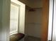 Walk-in closet with carpet floor, shelving and hanging rods, and bright window with blinds at 3008 River Hill Ln, Burlington, NC 27217