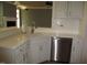 Open kitchen with white cabinets, stainless steel dishwasher, and a breakfast bar area at 3008 River Hill Ln, Burlington, NC 27217
