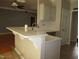Kitchen with a breakfast bar, white countertop, grey cabinets, and stainless steel appliances in the background at 3008 River Hill Ln, Burlington, NC 27217