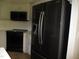 Kitchen with a black refrigerator, oven, microwave, white cabinets and tile backsplash at 3008 River Hill Ln, Burlington, NC 27217