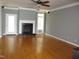 Spacious living room with hardwood floors, a fireplace, and neutral paint for a cozy atmosphere at 3008 River Hill Ln, Burlington, NC 27217