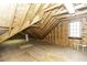 View of unfinished attic space with plywood and exposed rafters, and a small window at 3112 Lake Pointe Trl, Rocky Mount, NC 27804