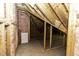 Unfinished attic space with exposed rafters and pink insulation at 3112 Lake Pointe Trl, Rocky Mount, NC 27804