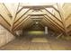 Spacious attic featuring exposed beams and wood floors offers ample storage or potential for conversion at 3112 Lake Pointe Trl, Rocky Mount, NC 27804
