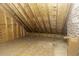 Unfinished attic space with exposed wood beams, providing a rustic, flexible storage solution at 3112 Lake Pointe Trl, Rocky Mount, NC 27804