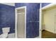 Bathroom features a toilet and glass shower, complemented by unique blue textured walls at 3112 Lake Pointe Trl, Rocky Mount, NC 27804