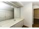 Bathroom featuring white vanity, large mirror, and doorway to another room at 3112 Lake Pointe Trl, Rocky Mount, NC 27804
