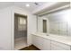 Bathroom with white cabinets, large mirror, and doorway to a separate shower/toilet area at 3112 Lake Pointe Trl, Rocky Mount, NC 27804