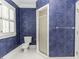 Stylish bathroom with unique blue textured walls, a toilet, and a glass-enclosed shower at 3112 Lake Pointe Trl, Rocky Mount, NC 27804