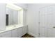 Well-lit bathroom features a vanity with white cabinets and a large mirror for a clean, classic look at 3112 Lake Pointe Trl, Rocky Mount, NC 27804