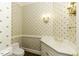 Elegant powder room featuring a pedestal sink with gold fixtures and floral wallpaper at 3112 Lake Pointe Trl, Rocky Mount, NC 27804
