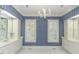 Bathroom showcasing double sinks, windows with shutters, and patterned wallpaper at 3112 Lake Pointe Trl, Rocky Mount, NC 27804