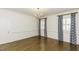 Bright bedroom with hardwood floors and decorative blue and white window treatments at 3112 Lake Pointe Trl, Rocky Mount, NC 27804