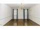 Spacious bedroom with hardwood floors and decorative blue and white window treatments at 3112 Lake Pointe Trl, Rocky Mount, NC 27804