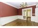 Formal dining room featuring hardwood floors, wainscoting, and a classic chandelier at 3112 Lake Pointe Trl, Rocky Mount, NC 27804