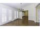Elegant dining room featuring hardwood floors, a stylish chandelier, and French doors to let in natural light at 3112 Lake Pointe Trl, Rocky Mount, NC 27804