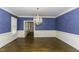 Dining room with hardwood floors, wainscoting, chandelier and large window at 3112 Lake Pointe Trl, Rocky Mount, NC 27804