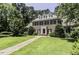An attractive brick home with dark shutters and manicured landscaping sits on a lush lawn at 3112 Lake Pointe Trl, Rocky Mount, NC 27804