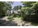 Brick estate home with a curved driveway and mature landscaping creates privacy at 3112 Lake Pointe Trl, Rocky Mount, NC 27804
