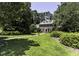 Lush green lawn surrounds this stately home with mature trees and manicured landscaping at 3112 Lake Pointe Trl, Rocky Mount, NC 27804