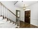 Entryway with staircase, paneled walls, hardwood floors and a decorative chandelier at 3112 Lake Pointe Trl, Rocky Mount, NC 27804