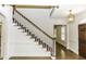 Bright foyer with white wainscoting, a staircase, and hardwood floors at 3112 Lake Pointe Trl, Rocky Mount, NC 27804