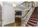 Entryway with paneled walls, staircase, hardwood floors, and view into dining room at 3112 Lake Pointe Trl, Rocky Mount, NC 27804