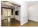 Hallway featuring wood floors, wainscoting, built-in shelving and an adjacent room with a chandelier at 3112 Lake Pointe Trl, Rocky Mount, NC 27804