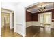 Spacious hallway with dark hardwood floors, wainscoting, and open doorways to other rooms at 3112 Lake Pointe Trl, Rocky Mount, NC 27804