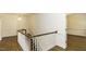 Bright hallway featuring hardwood floors, white walls, and a decorative light fixture at 3112 Lake Pointe Trl, Rocky Mount, NC 27804
