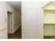 Hallway featuring hardwood floors, wainscoting, and access to a walk-in closet at 3112 Lake Pointe Trl, Rocky Mount, NC 27804