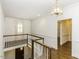 Bright hallway featuring hardwood floors, white walls, and a decorative light fixture at 3112 Lake Pointe Trl, Rocky Mount, NC 27804