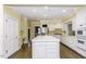 Bright, modern kitchen with white cabinetry, an island with sink, and stainless steel appliances at 3112 Lake Pointe Trl, Rocky Mount, NC 27804