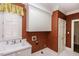 Cozy laundry room with sink and storage cabinets with shuttered window at 3112 Lake Pointe Trl, Rocky Mount, NC 27804