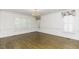 Bright living room featuring hardwood floors, white walls, and plantation shutters at 3112 Lake Pointe Trl, Rocky Mount, NC 27804