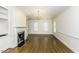 Living room with hardwood floors, fireplace, chandelier, and ample space with natural light from the windows at 3112 Lake Pointe Trl, Rocky Mount, NC 27804
