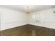 Bright living room featuring hardwood floors, white walls, and plantation shutters at 3112 Lake Pointe Trl, Rocky Mount, NC 27804