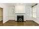 Bright living room with hardwood floors, wainscoting, custom built-ins and a black marble fireplace surround at 3112 Lake Pointe Trl, Rocky Mount, NC 27804