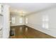 Spacious living room featuring wood floors, fireplace, wainscoting and natural light from large windows at 3112 Lake Pointe Trl, Rocky Mount, NC 27804
