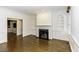 Bright living room with hardwood floors, wainscoting, custom built-ins and a marble fireplace surround at 3112 Lake Pointe Trl, Rocky Mount, NC 27804