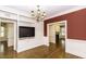 Spacious living room featuring hardwood floors, built-in shelves and a modern TV at 3112 Lake Pointe Trl, Rocky Mount, NC 27804