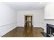 Bright living room with hardwood floors, wainscoting and fireplace with black marble surround at 3112 Lake Pointe Trl, Rocky Mount, NC 27804