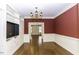Spacious living room featuring hardwood floors, built-in shelves, a modern TV and wainscoting at 3112 Lake Pointe Trl, Rocky Mount, NC 27804